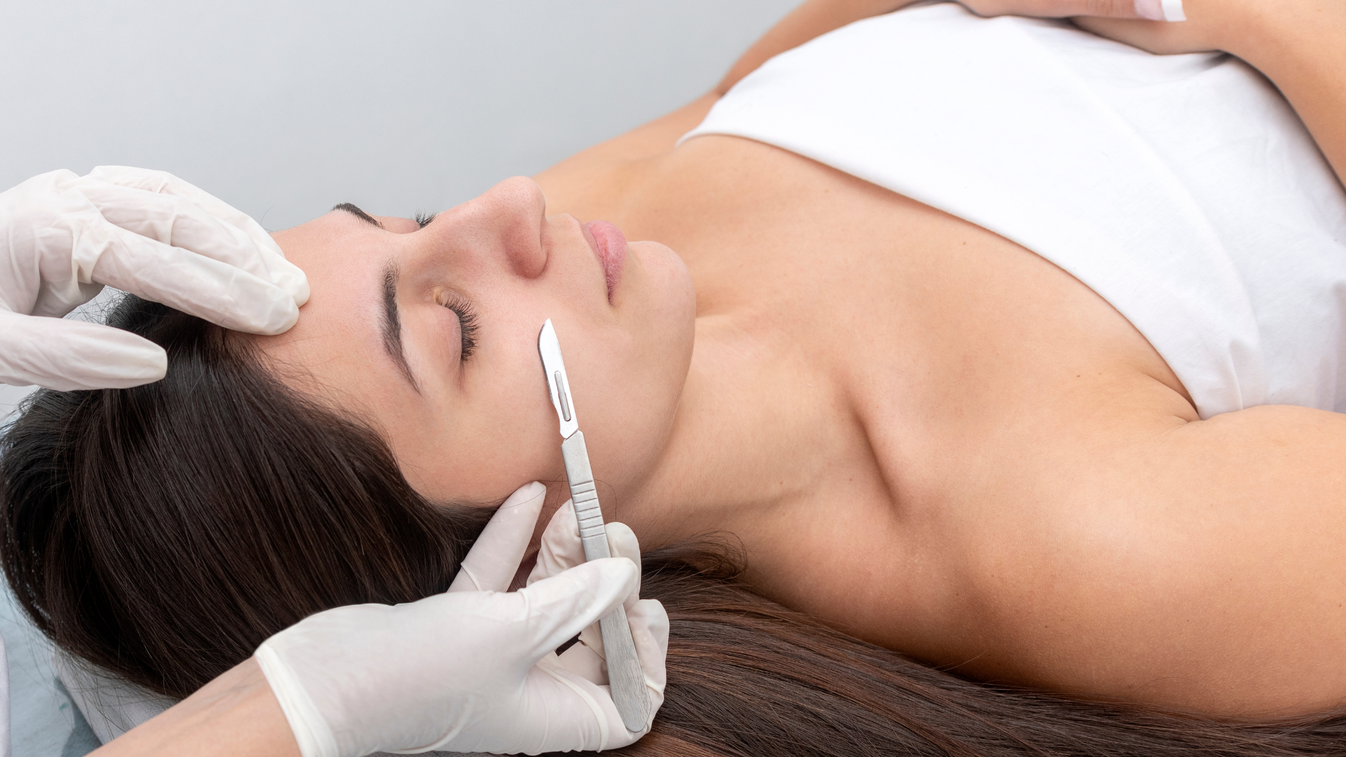 a woman is laying on a bed with a white mask on her face .