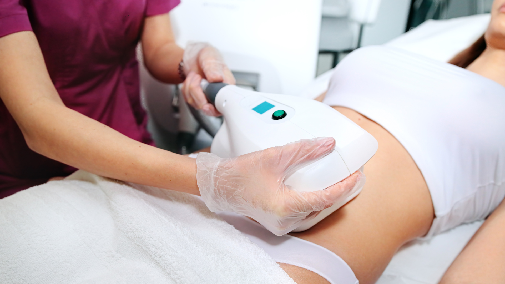 A woman is getting a stomach treatment at a beauty salon.