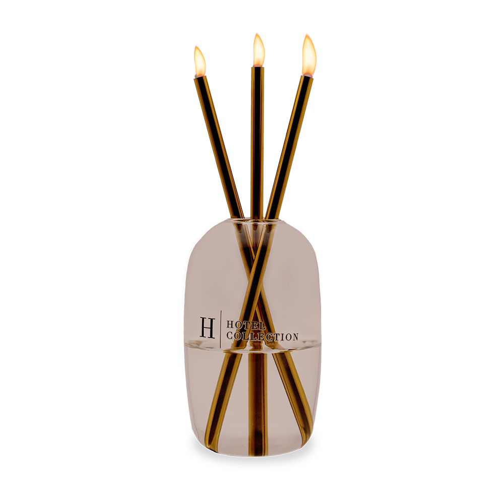 A vase with three candles in it and the letter h on it