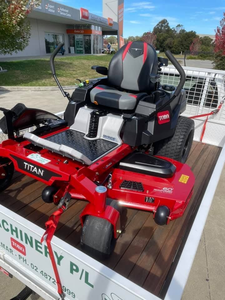 A Titan Lawn Mower is Sitting on a Trailer — Ireland's Machinery Pty Ltd in Braemar, NSW
