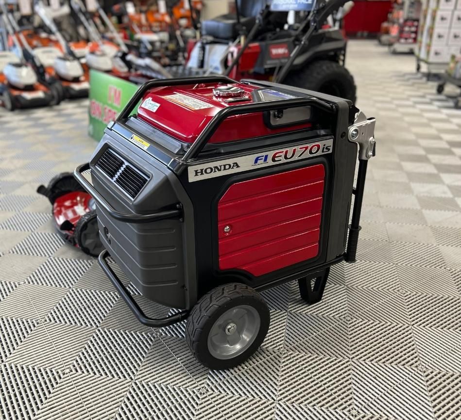 A Red and Black Honda Generator is Sitting on a Cart in a Store — Ireland's Machinery Pty Ltd In Braemar, NSW