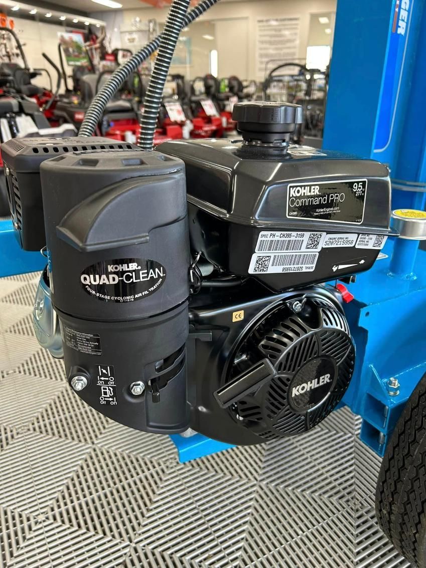 A Black Engine Is Sitting On Top Of A Blue Lawn Mower — Ireland's Machinery Pty Ltd In Braemar, NSW