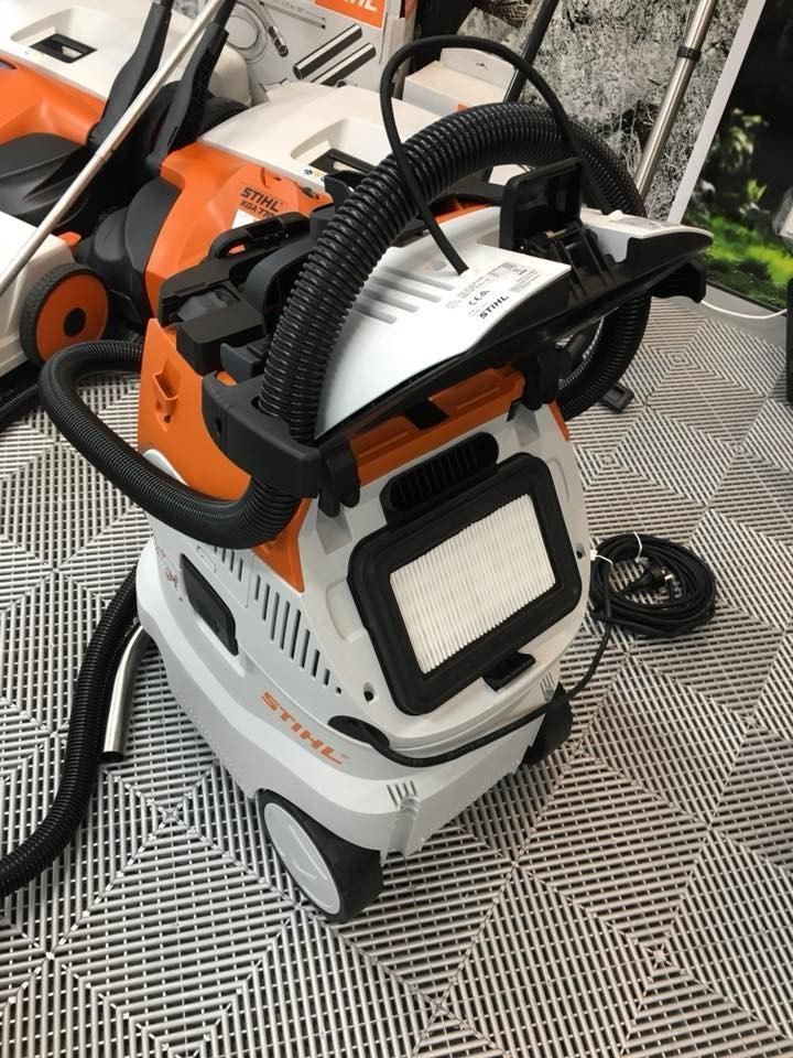 A White And Orange Vacuum Cleaner Is Sitting On A Tiled Floor — Ireland's Machinery Pty Ltd In Braemar, NSW