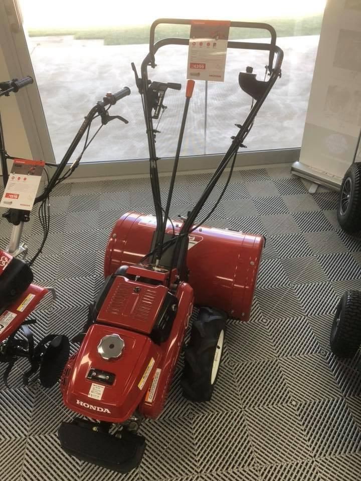 A Red Lawn Mower is Sitting in a Showroom Next to a Window — Ireland's Machinery Pty Ltd In Braemar, NSW