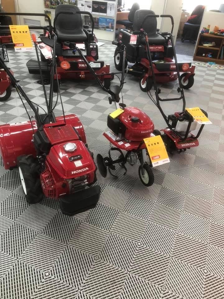 A Row of Lawn Mowers and Tractors Are Lined Up in a Showroom — Ireland's Machinery Pty Ltd In Braemar, NSW