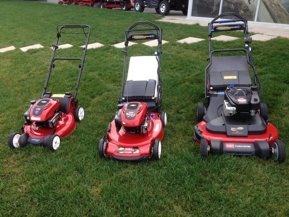 Three Lawn Mowers Are Sitting on a Lush Green Lawn — Ireland's Machinery Pty Ltd In Braemar, NSW
