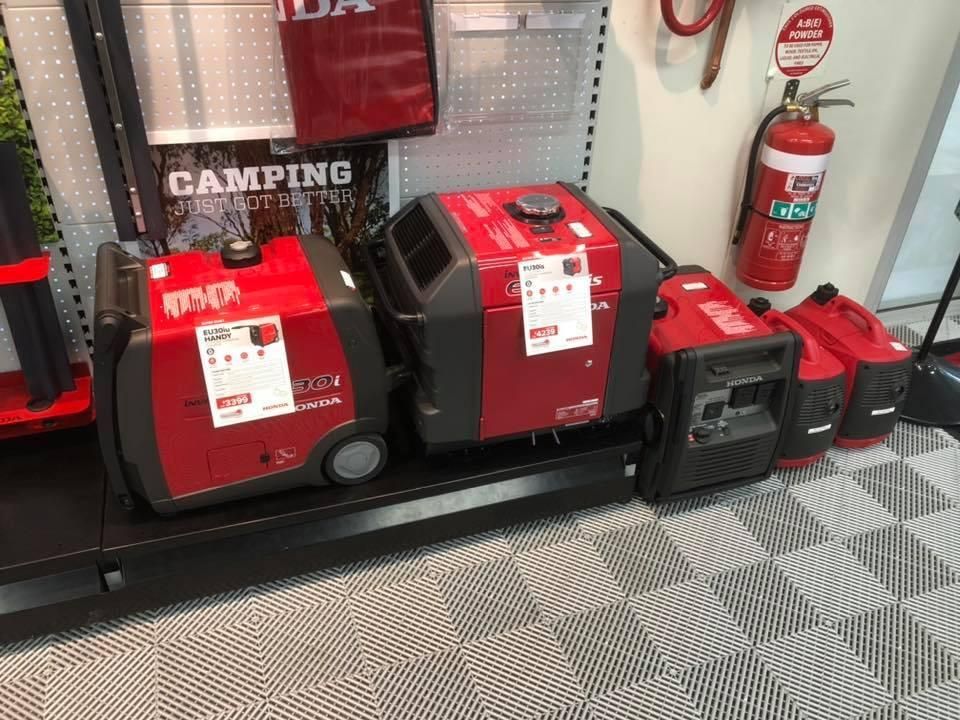 Three Red and Black Generators Are Sitting on a Shelf in a Store — Ireland's Machinery Pty Ltd In Braemar, NSW