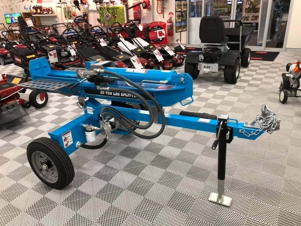 A Blue Log Splitter is Sitting on a Trailer in a Showroom — Ireland's Machinery Pty Ltd In Braemar, NSW