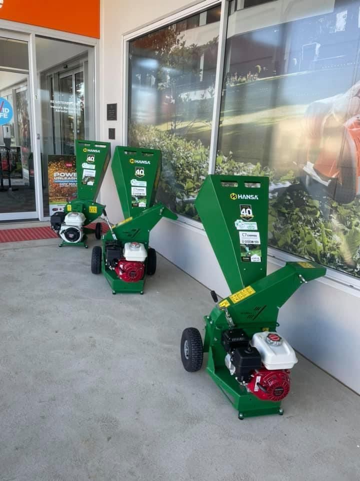 Two Green Shredders Are Parked In Front Of A Building — Ireland's Machinery Pty Ltd In Braemar, NSW
