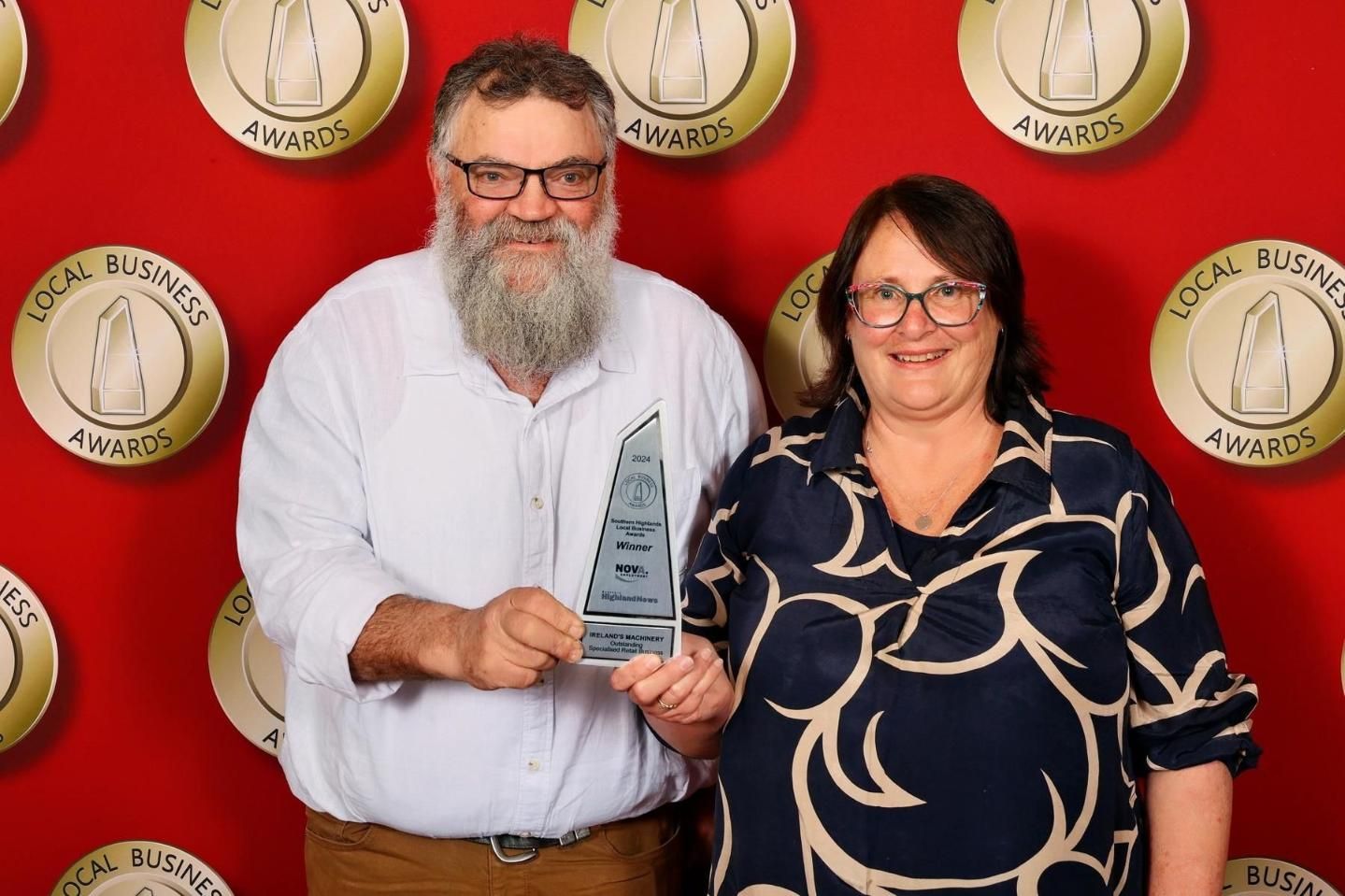A Man and a Woman Are Standing Next to Each Other Holding an Award — Ireland's Machinery Pty Ltd In Braemar, NSW