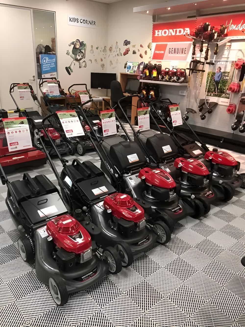 A Row of Lawn Mowers Are Lined Up in a Store — Ireland's Machinery Pty Ltd In Braemar, NSW