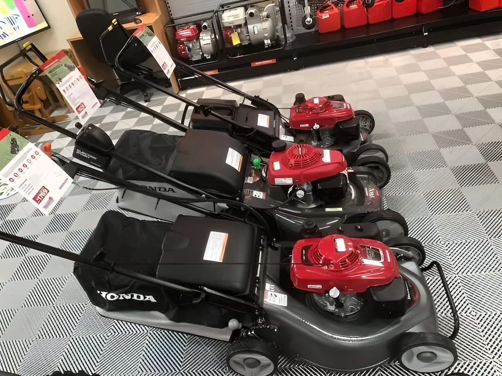 A Row of Honda Lawn Mowers Are Lined Up in a Store — Ireland's Machinery Pty Ltd In Braemar, NSW