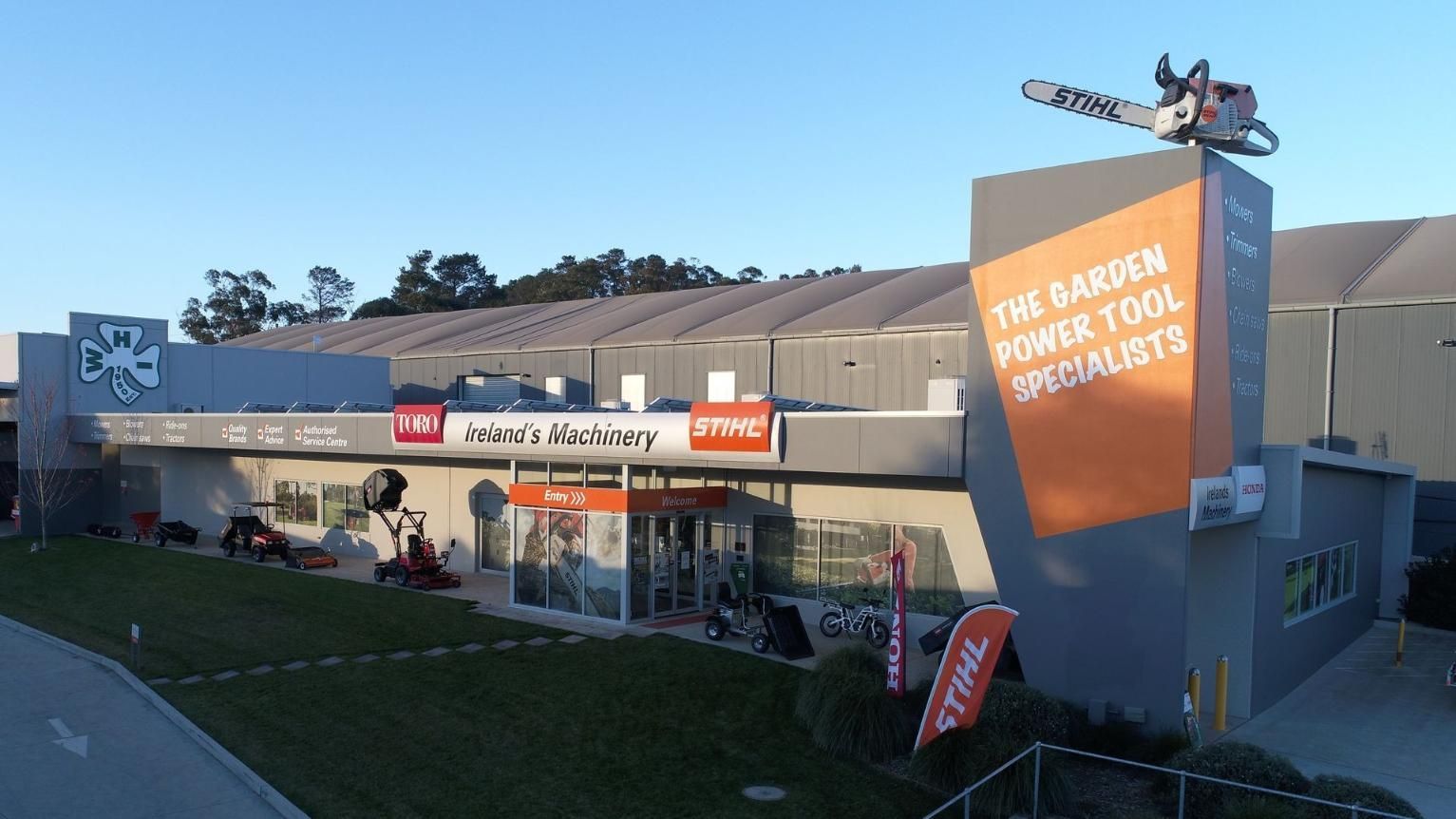 A Large Building With A Sign That Says The Garden Power Tool Specialists — Ireland's Machinery Pty Ltd In Braemar, NSW
