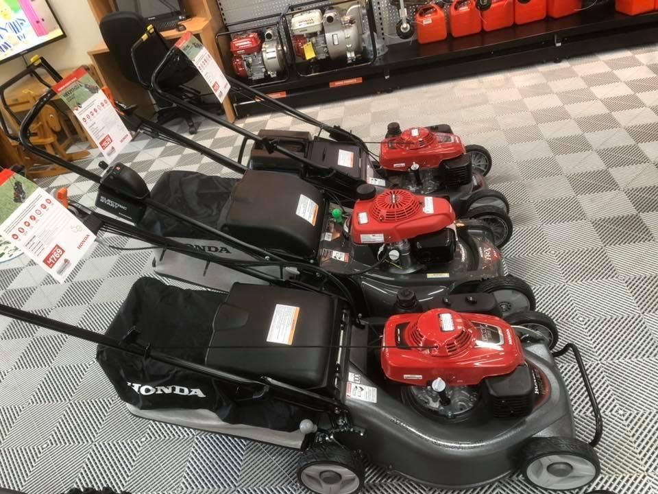 A Row of Lawn Mowers Are Lined Up in a Store β Ireland's Machinery Pty Ltd In Braemar, NSW