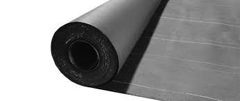 A close up of a roll of roofing material on a white background.