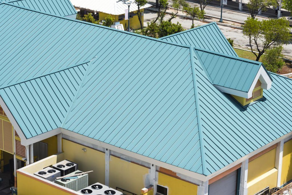 An aerial view of a house with a  commercial steel roof