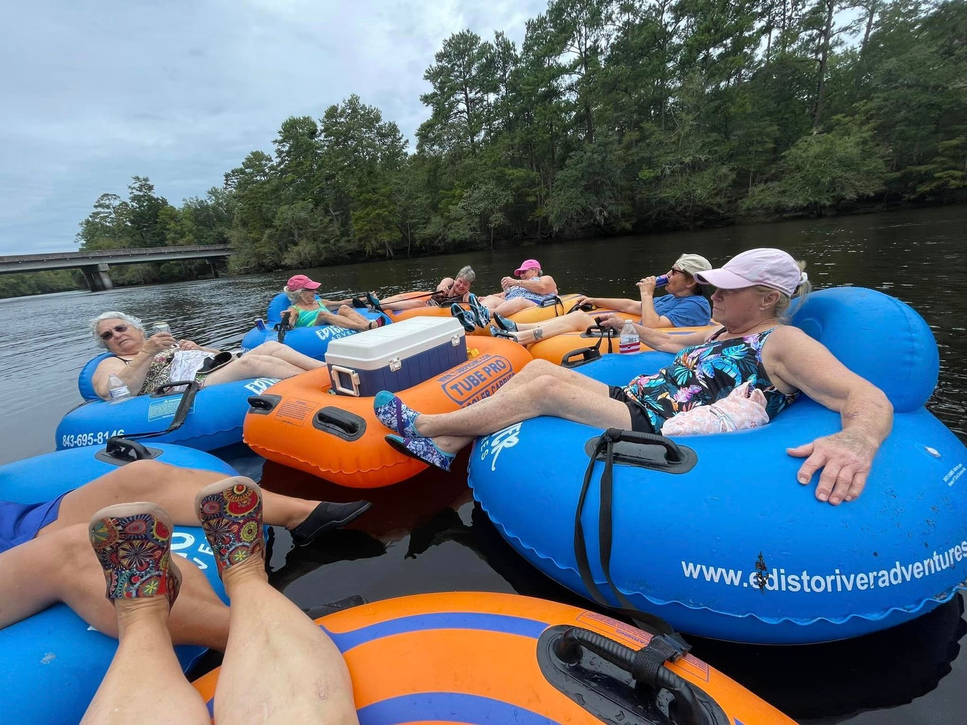A group of people are floating on tubes on a river.