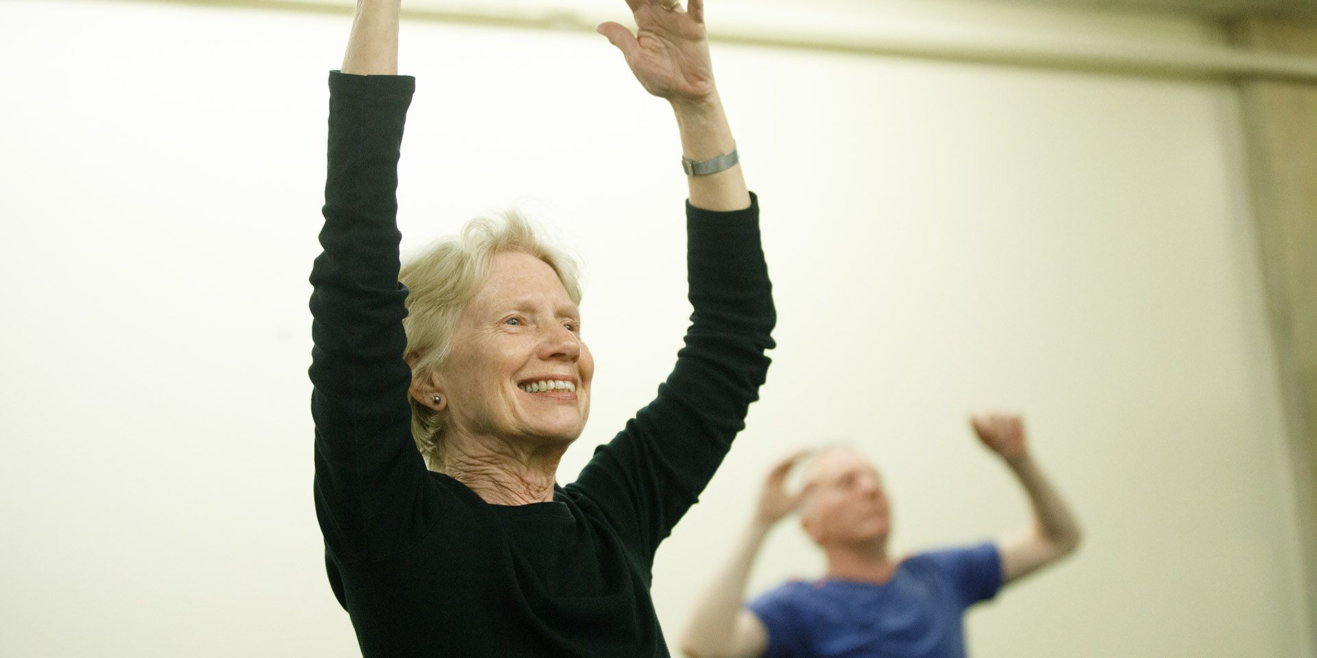 A woman is doing a yoga pose in a park.