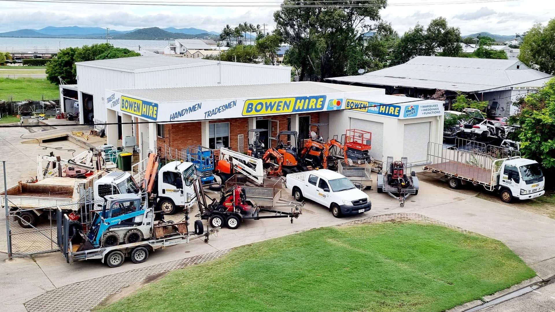 Aerial View of A Busy Auto Shop with Several Vehicles — Bowen Hire in Airlie Beach, QLD