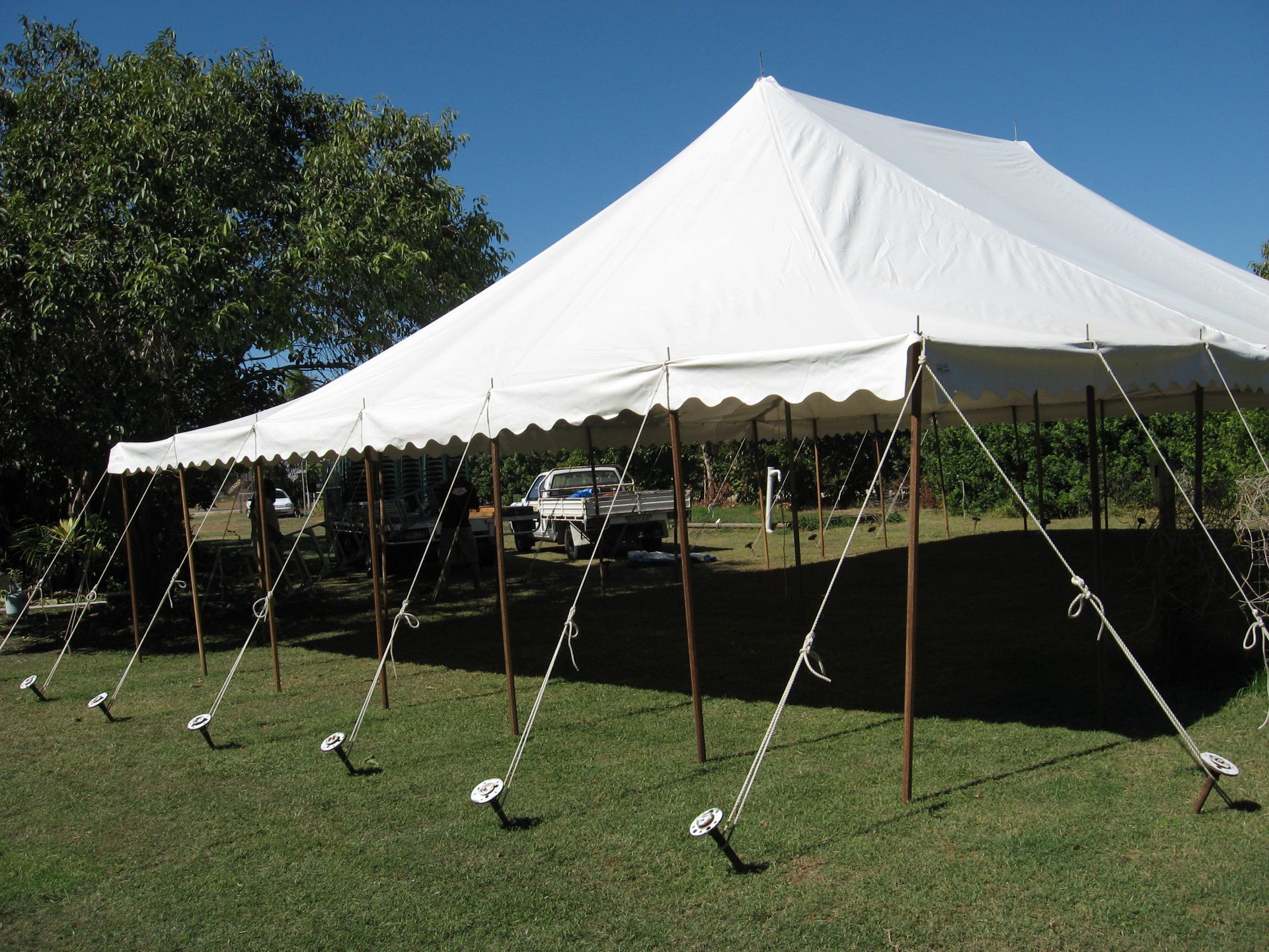 Large White Event Tent on A Grassy Field Under a Blue Sky — Bowen Hire in Airlie Beach, QLD