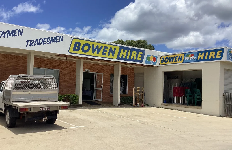 Bowen Hire Storefront With Parked Utility Truck Under a Blue and Yellow Sign — Bowen Hire in Bowen, QLD