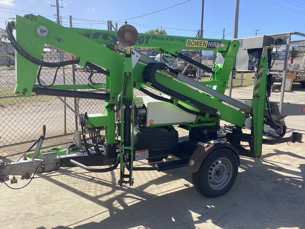 Green Mobile Drilling Rig on a Trailer in an Outdoor Lot, With Chain-link Fence — Bowen Hire in Bowen, QLD