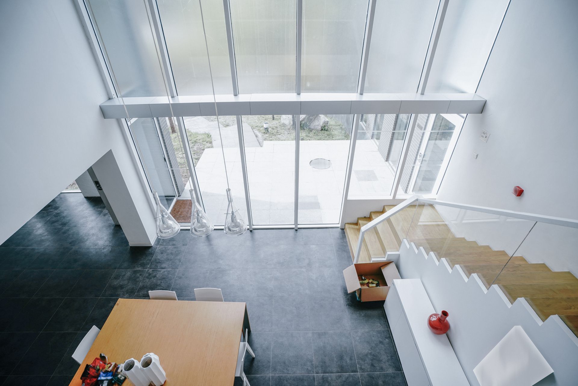 An aerial view of a room with stairs and a table