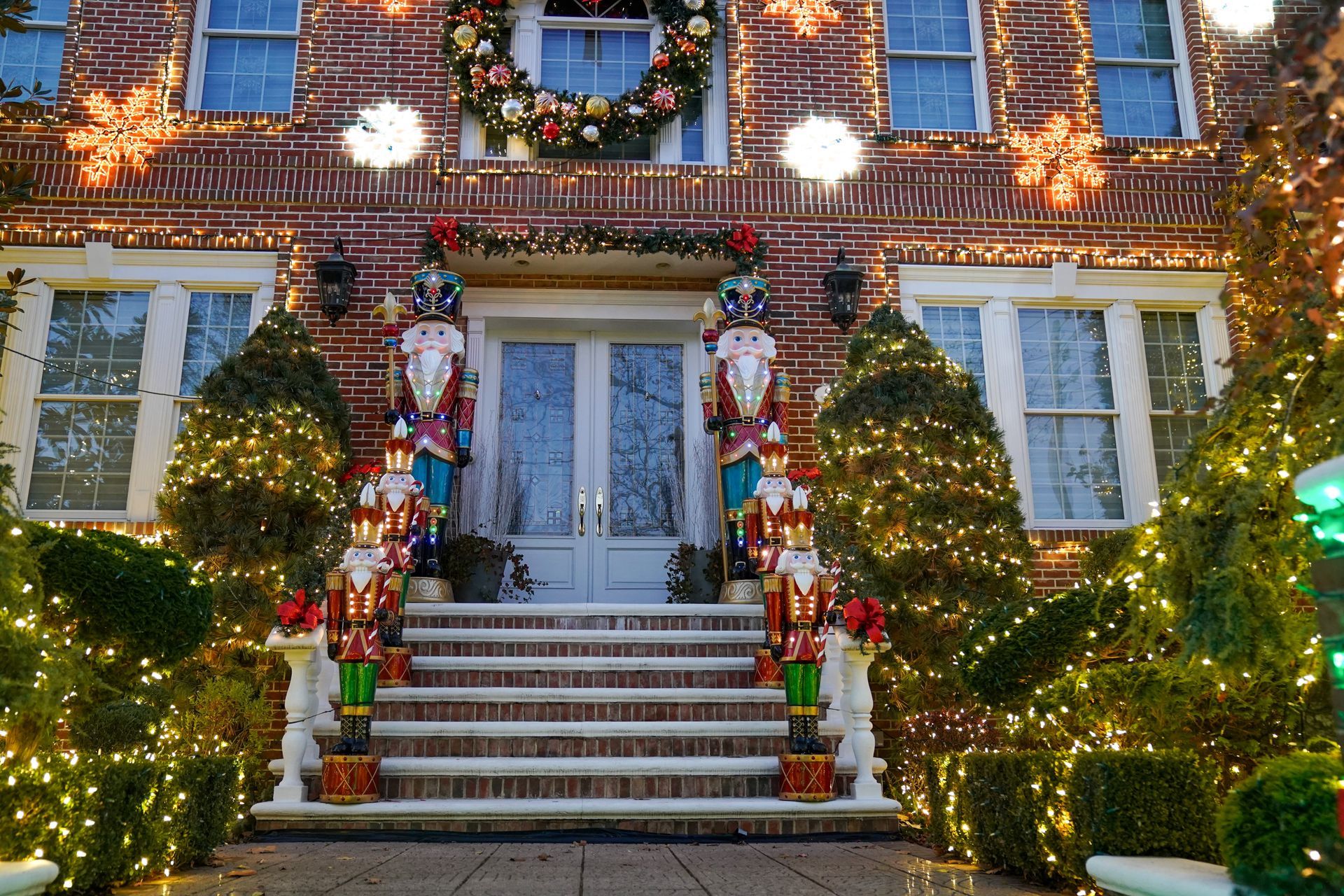 A man and a woman are looking at clothes in a store window.