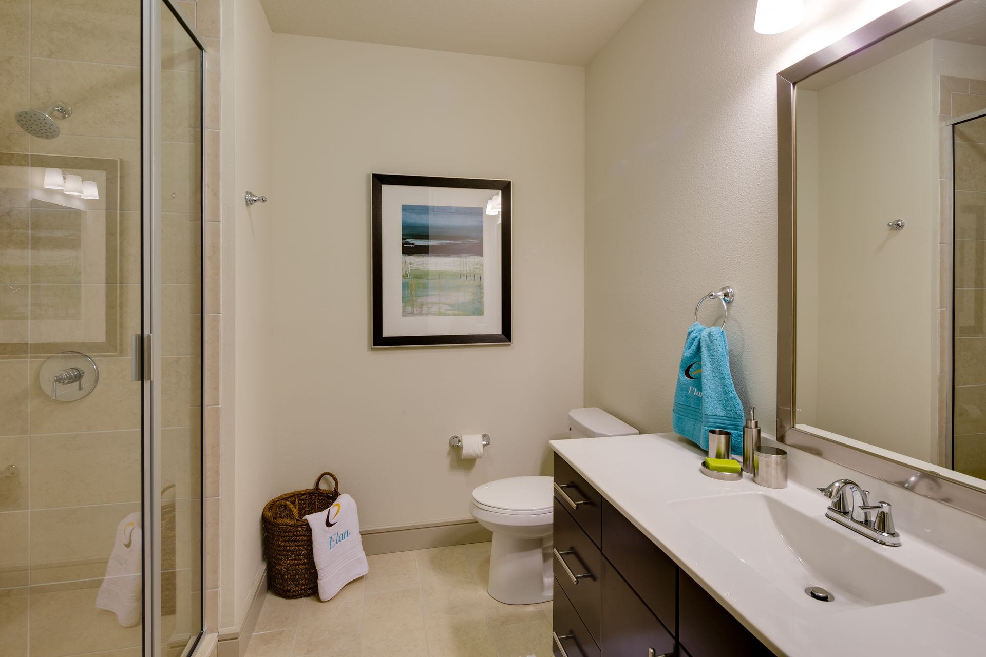 A bathroom with a toilet , sink and mirror