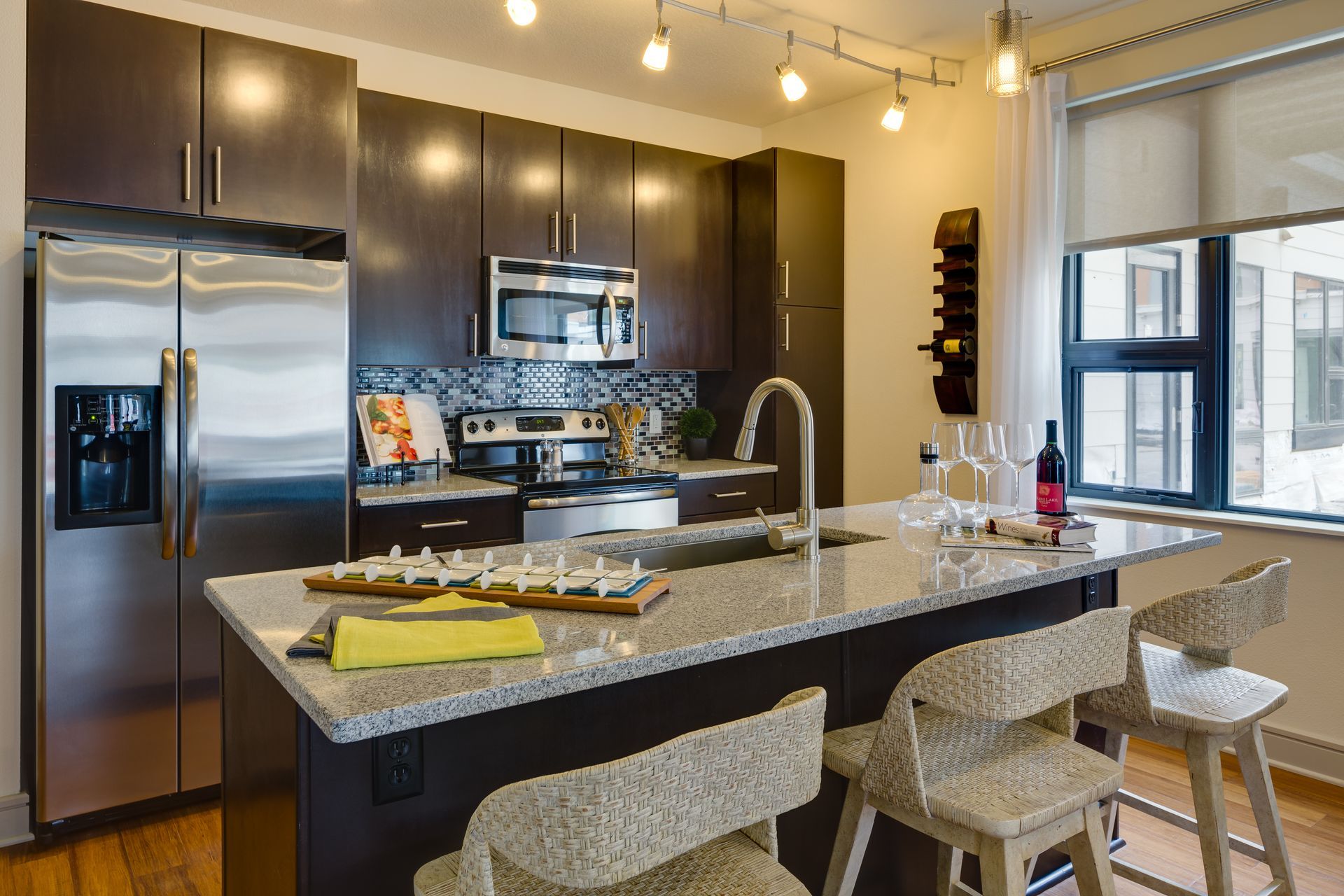 A kitchen with stainless steel appliances and granite counter tops.
