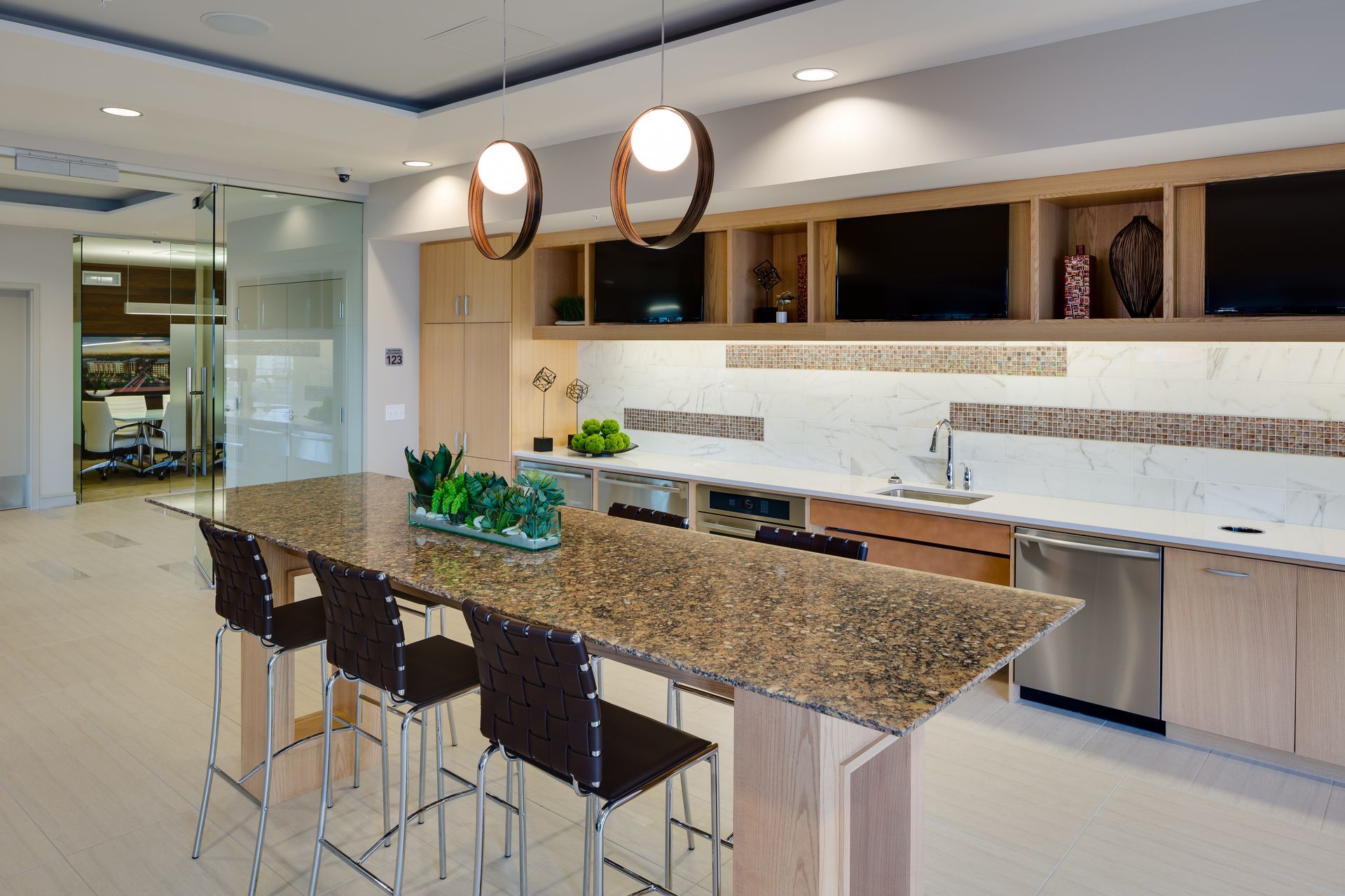 A kitchen with granite counter tops and stainless steel appliances