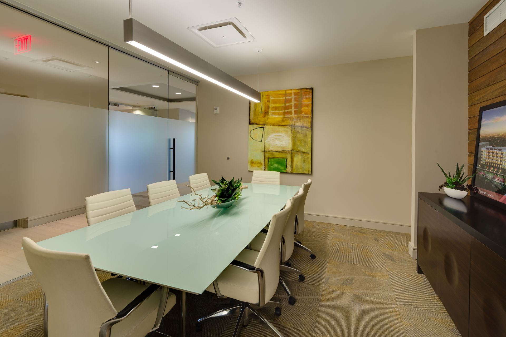 A conference room with a long table and chairs