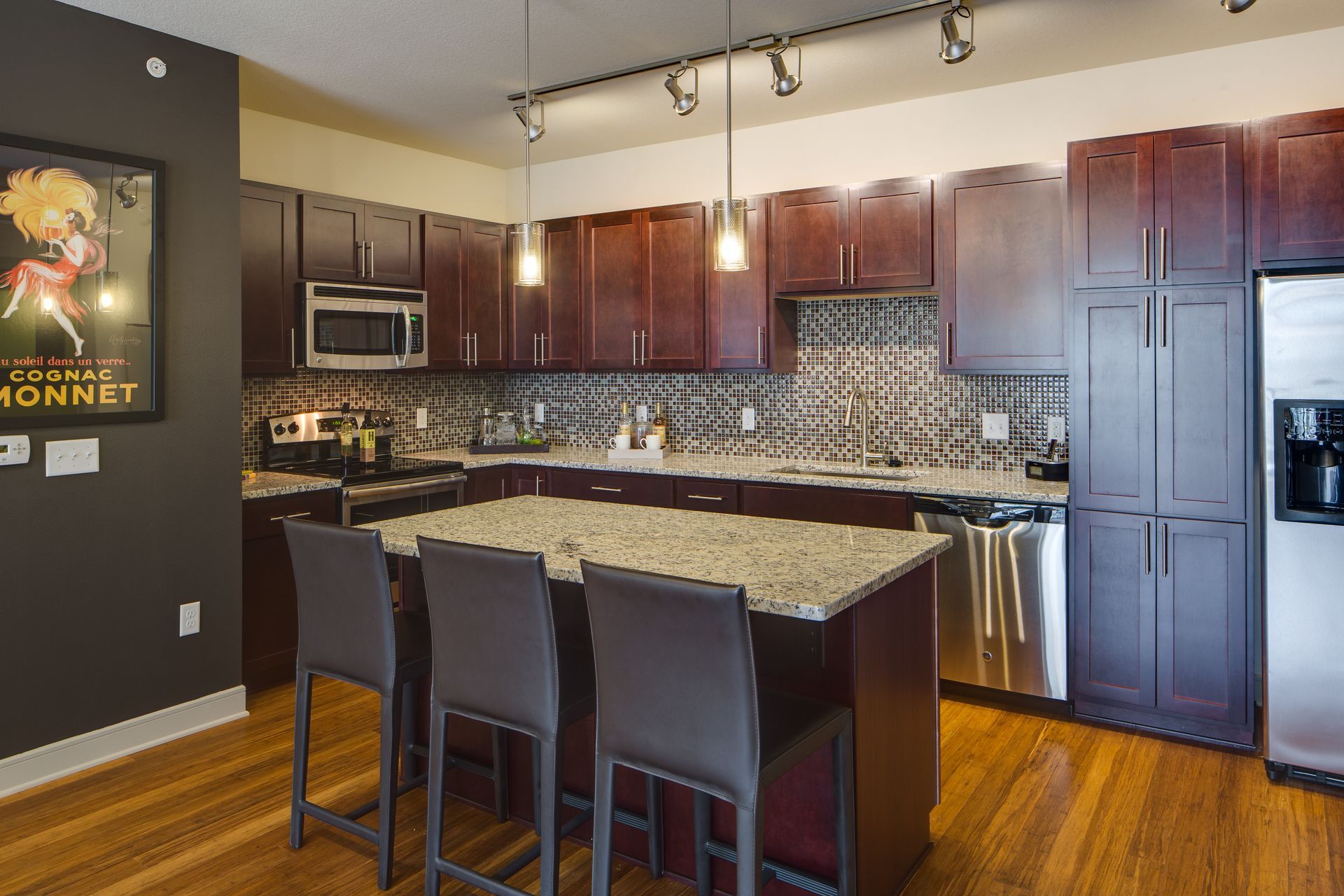 A kitchen with stainless steel appliances and granite counter tops