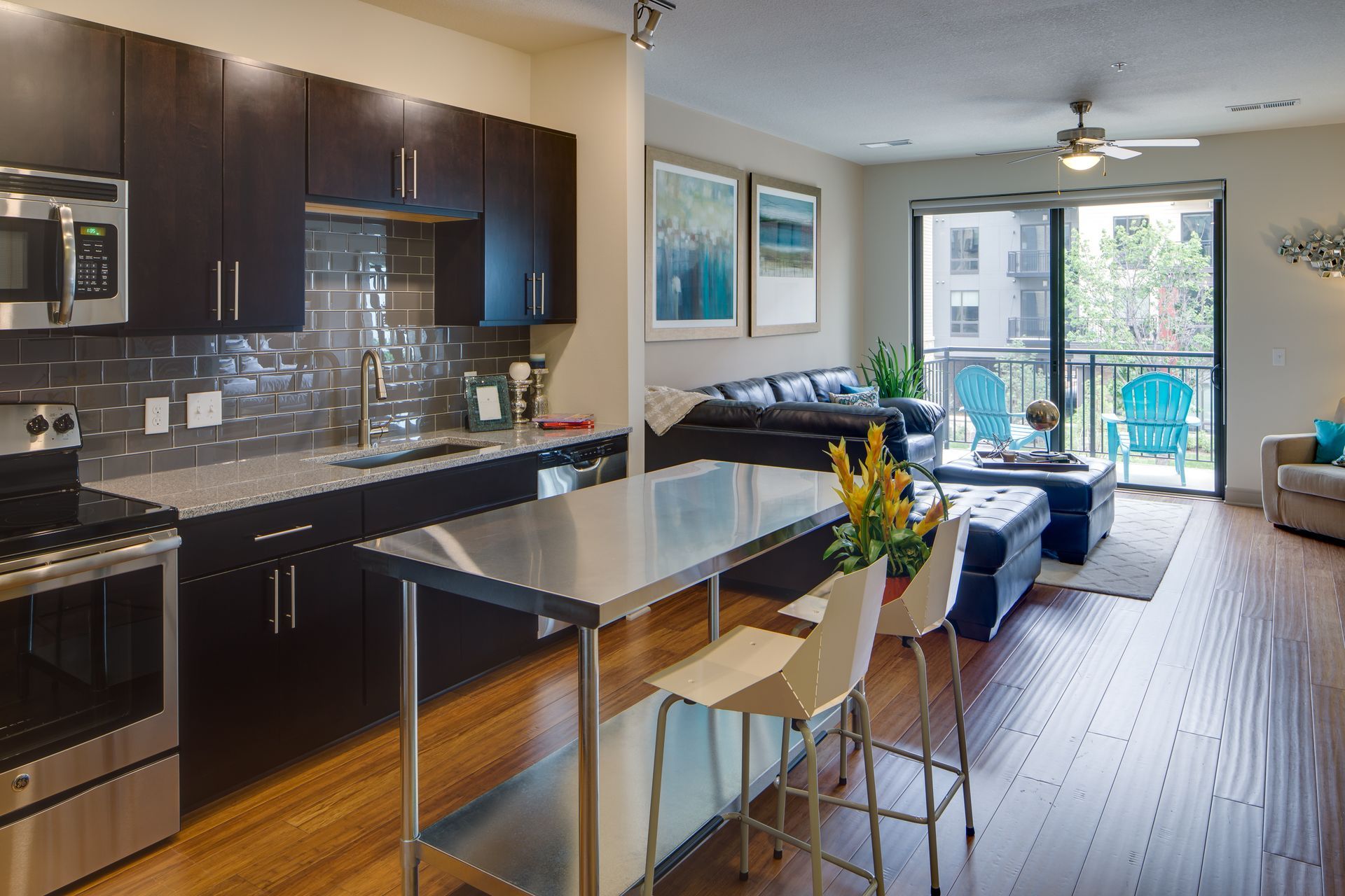 A kitchen with stainless steel appliances and wooden floors
