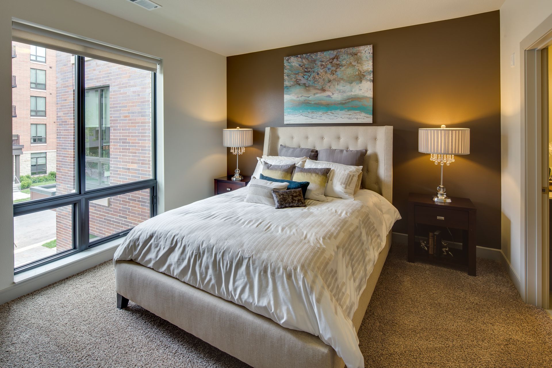 A bedroom with a large bed and a large window