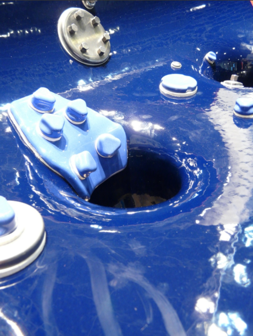 A group of people are sitting around a table with coffee cups and papers