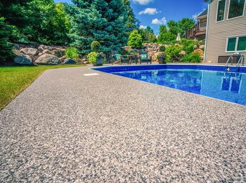 Premium floor coating surrounding a large swimming pool.