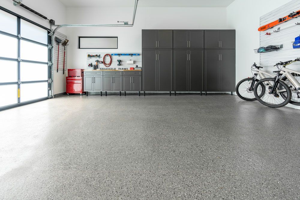 A garage with storage, and floor coating. 