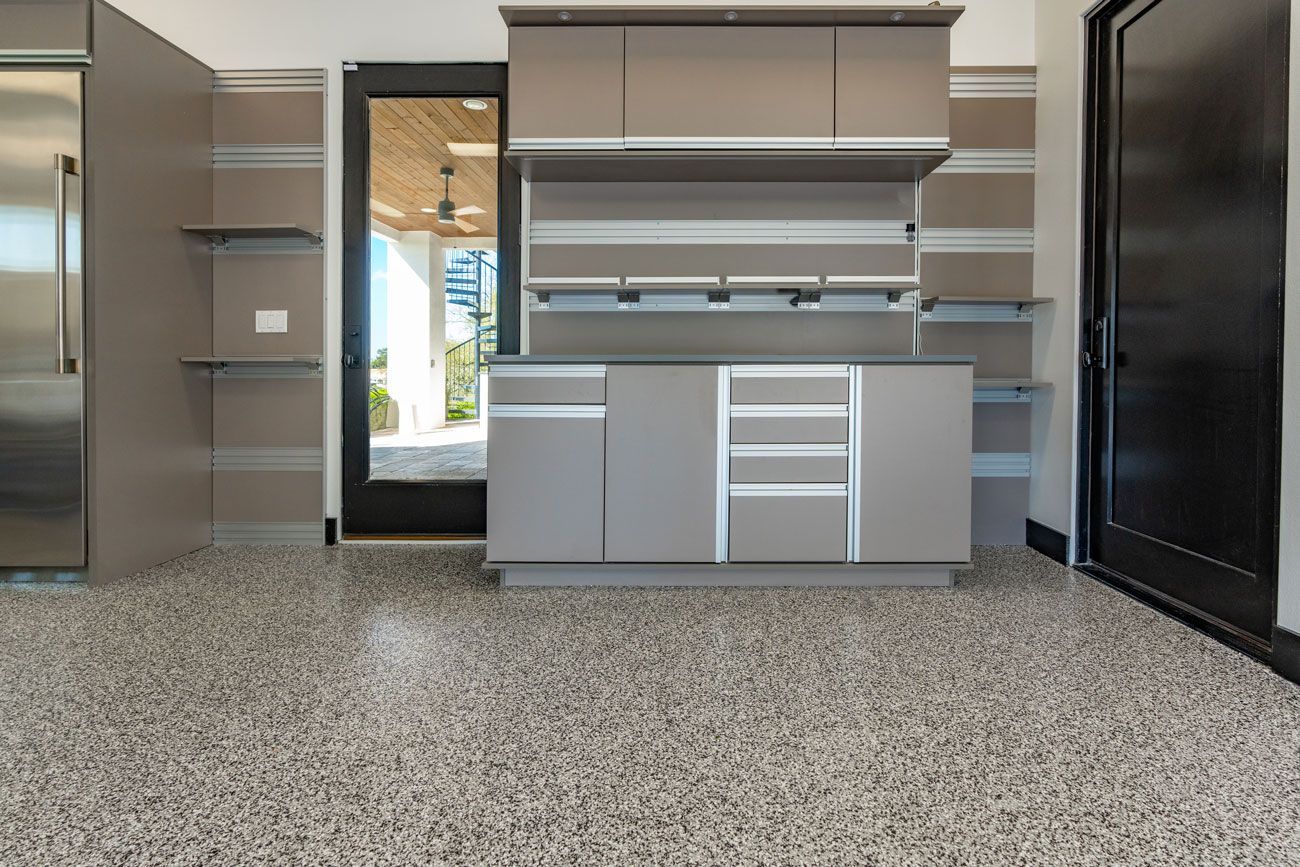 A kitchen with stainless steel appliances and a granite floor.