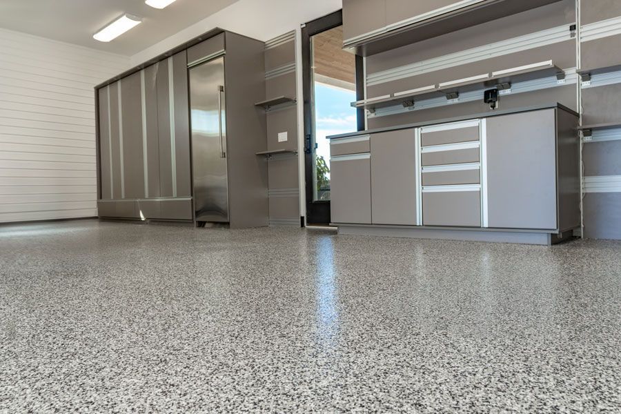 A garage with a concrete floor and cabinets.