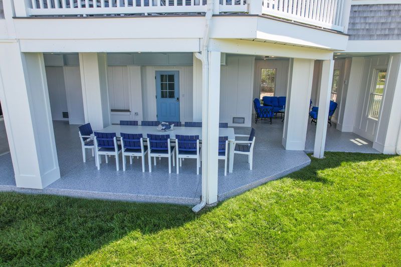 An aerial view of a covered patio with a table and chairs.