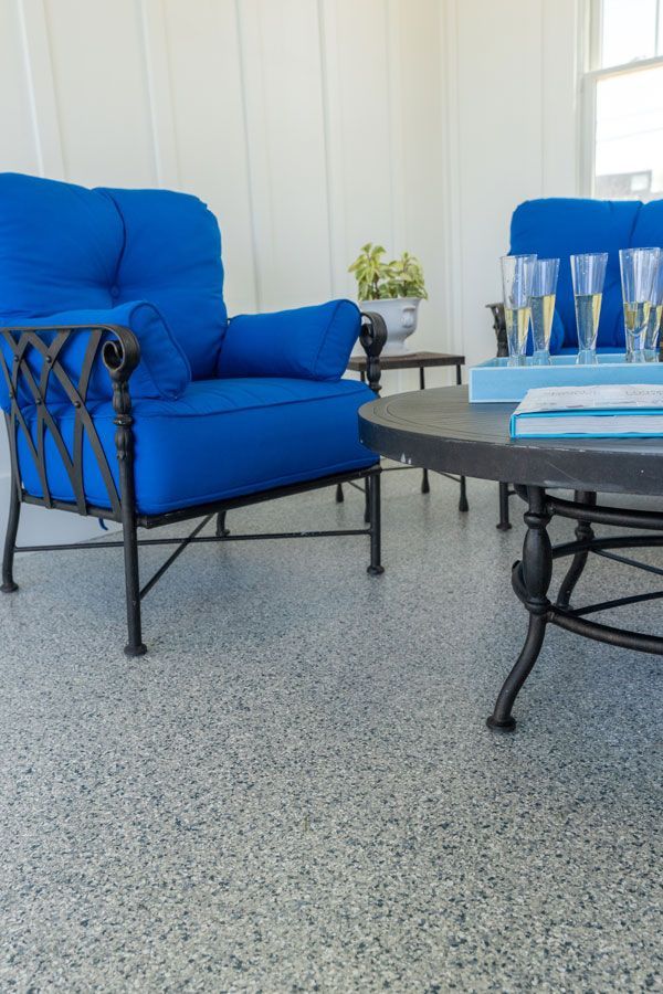 A living room with two blue chairs and a coffee table