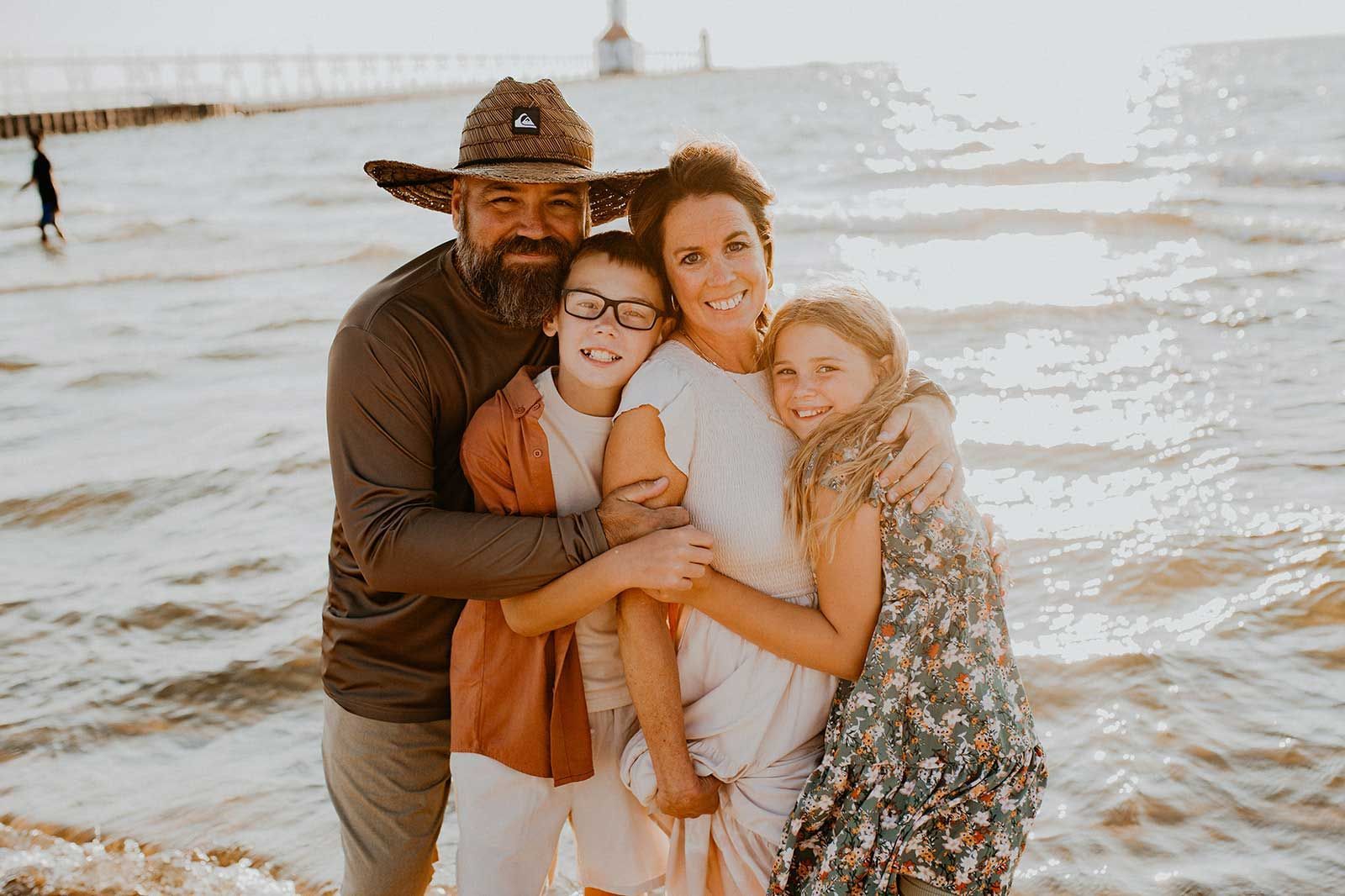A family is posing for a picture on a wooden bridge.