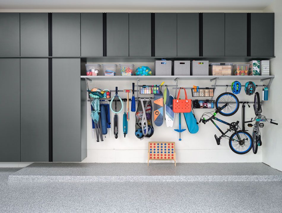 A garage with a lot of storage space and a bicycle hanging on the wall.