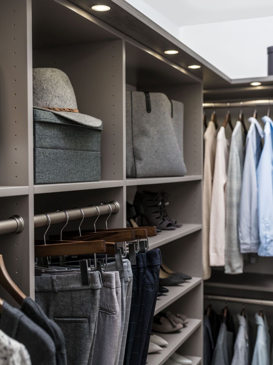 A closet filled with clothes and a hat
