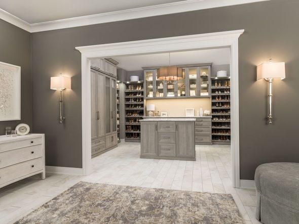 Luxury custom walk-in closet featuring a central island and ample storage.
