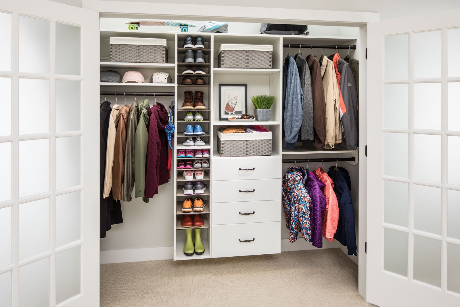 A closet filled with lots of clothes and shoes.
