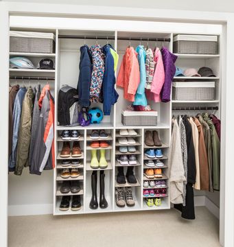 A custom closet filled with lots of clothes and shoes.