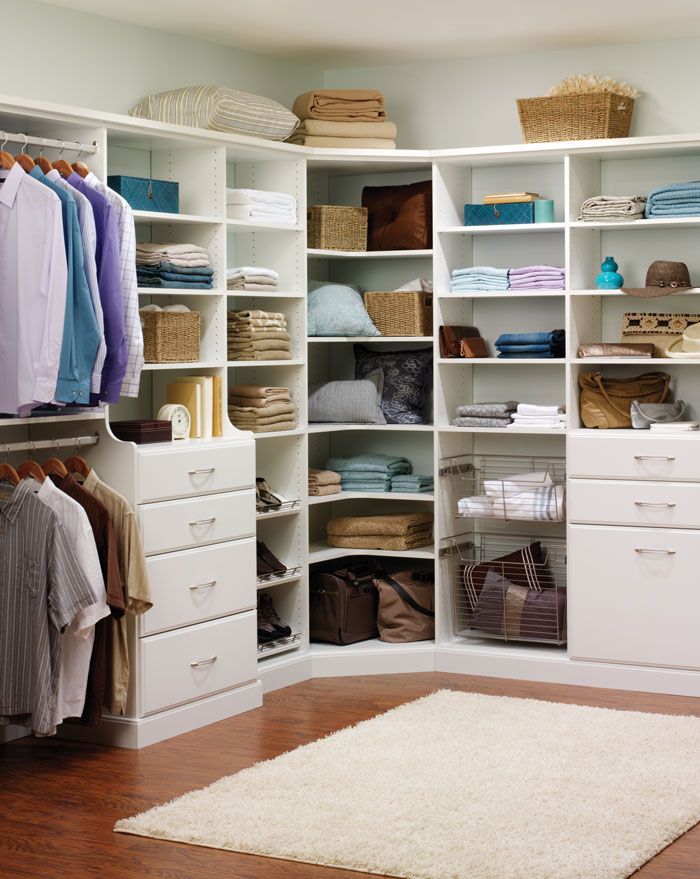 A walk in closet filled with clothes and baskets