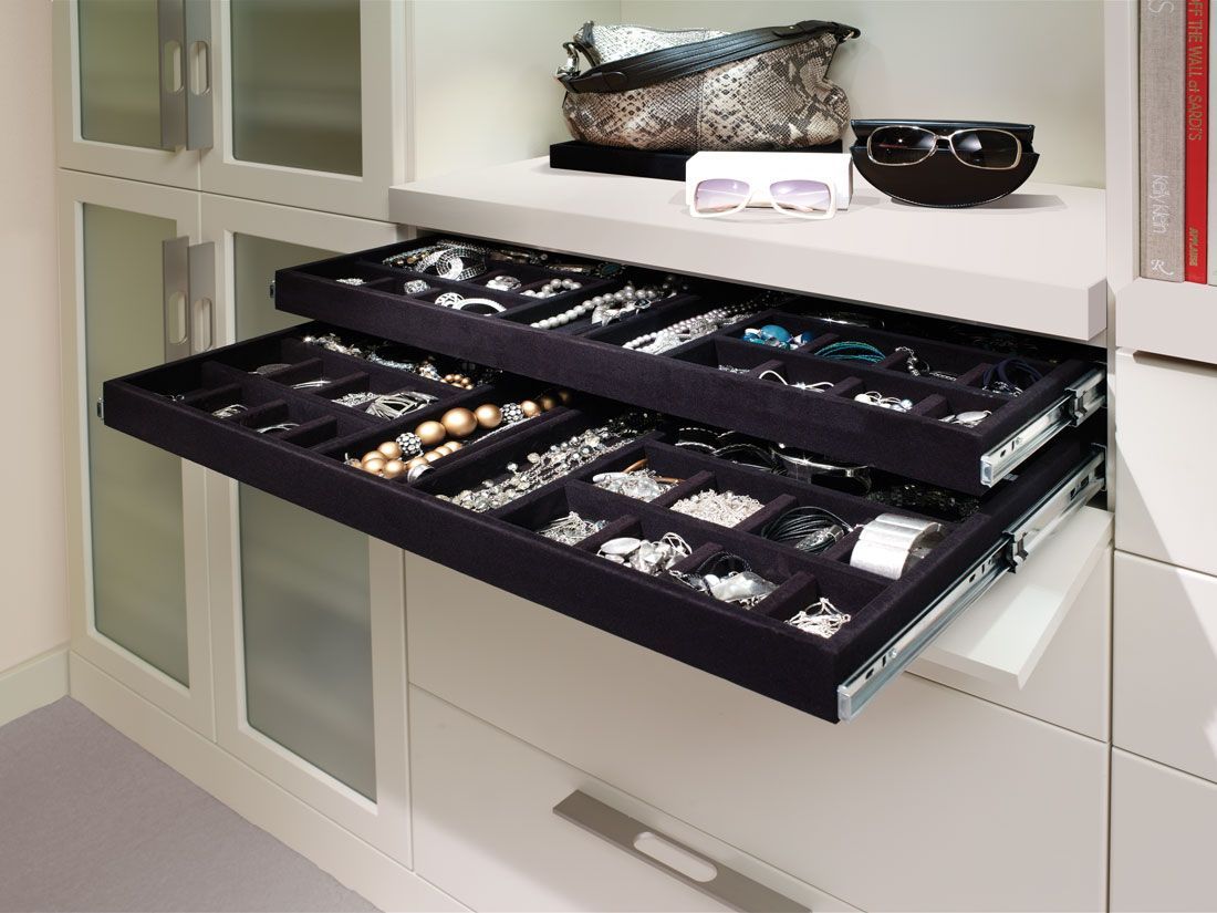 An opened velvet jewelry drawer in closet.